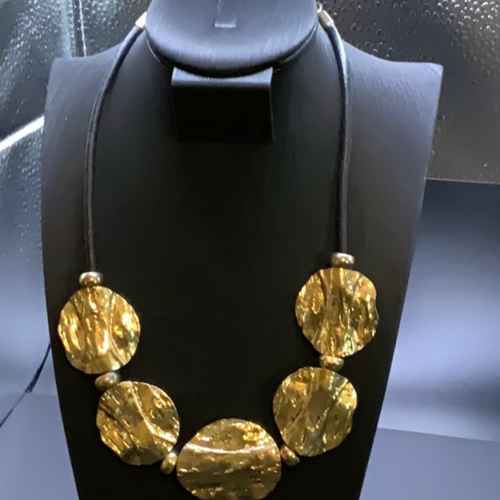 Gold tone metal and black rubber necklace adjustable up to 17”